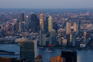 The sun sets on the United Nations and buildings in Long Island City.