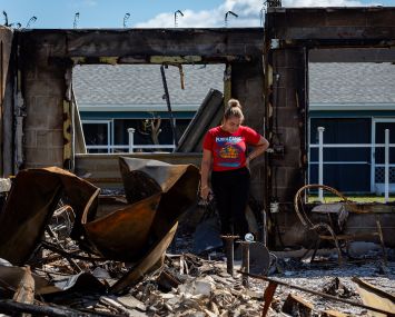 A woman looking at her burned out home after Hurricane Milton.