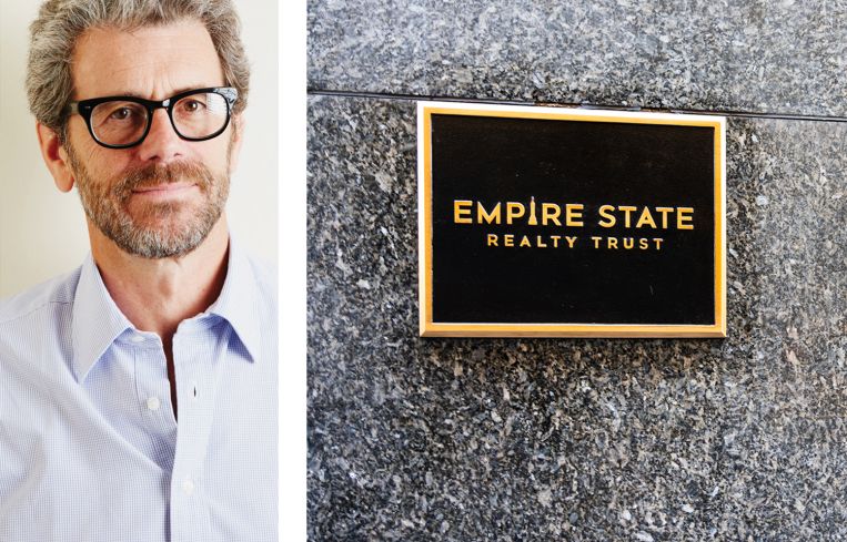 Anthony Malkin, CEO of Empire State Realty Trust, and their logo on a plaque.