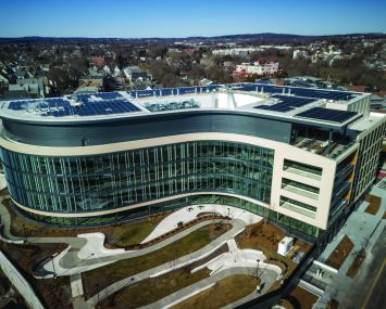 A modern, s-shaped building as viewed from the air.