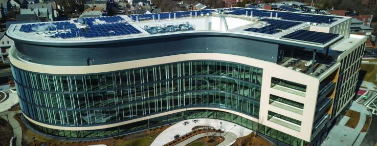 A modern, s-shaped building as viewed from the air.