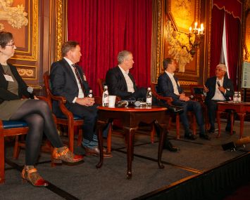 People sitting on a panel about commercial real estate.