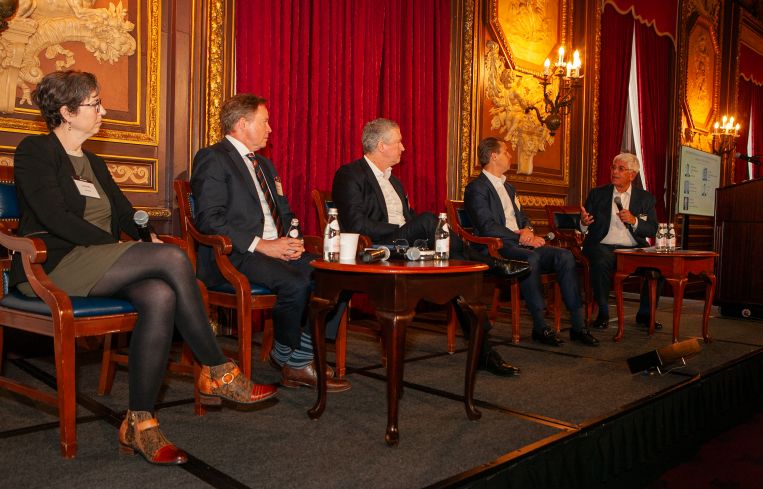 People sitting on a panel about commercial real estate.