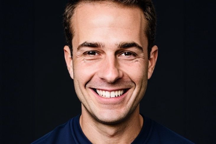 A man smiling in a t-shirt.