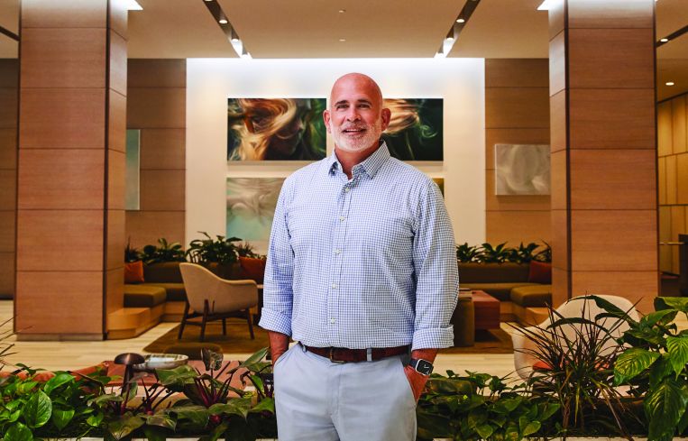A man standing in a building lobby.