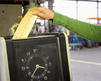 Someone inserting a punchcard into a meter box.