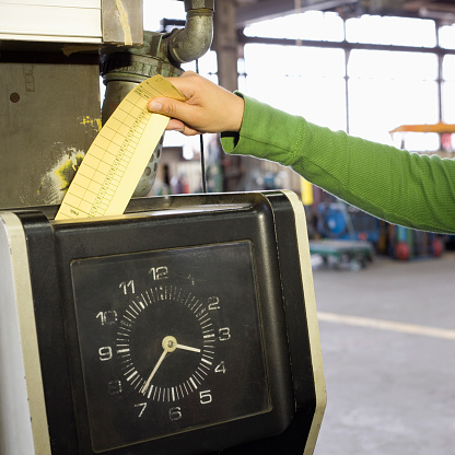 Someone inserting a punchcard into a meter box.