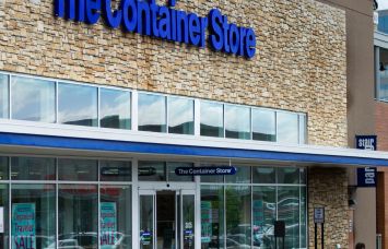 Signs on The Container Store, Party City, and Big Lots stores