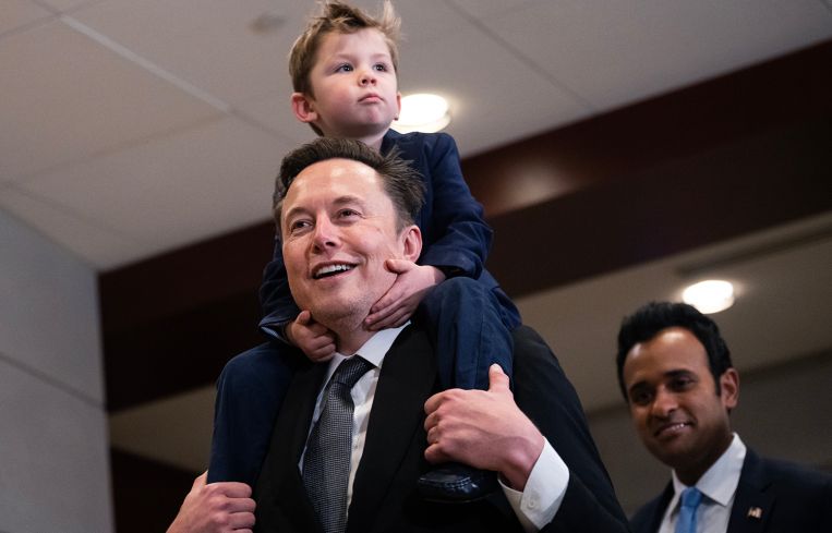 Elon Musk with his son, and Vivek Ramaswamy make their way to a meeting in the Capitol Visitor Center.