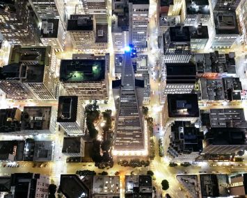 Aerial view of a city lighted up with buildings.