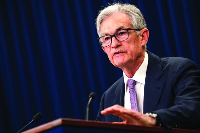 A man in glasses at a podium talking.