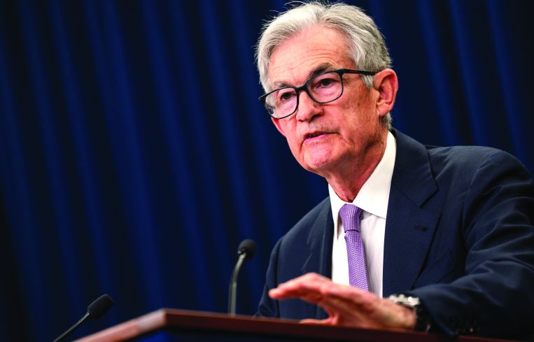 A man in glasses at a podium talking.