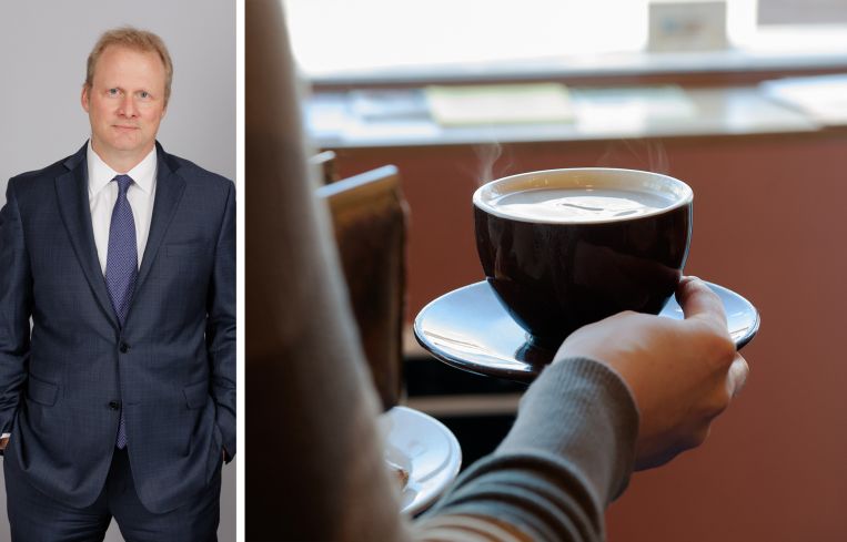 REBNY Vice President of Market Data Keith DeCoster and a customer carries a cup of coffee at a Brooklyn coffee shop.