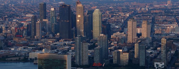 The sun sets on the United Nations and buildings in Long Island City.