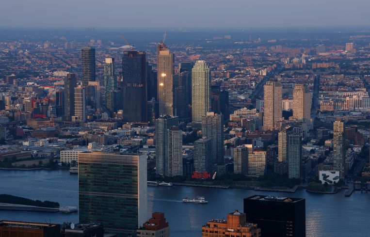 The sun sets on the United Nations and buildings in Long Island City.