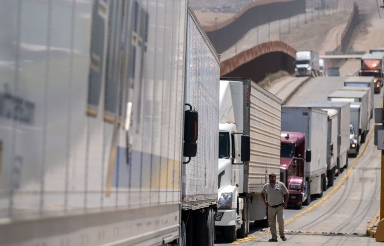 Cargo truck drivers line up to cross to the United States from Mexico.