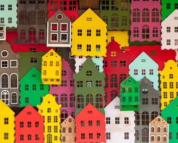 An illustration of colorful houses packed in together.