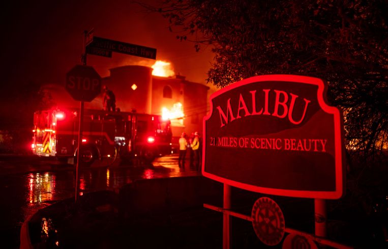 Firefighters battle winds and flames as multiple beachfront homes go up in flames along Pacific Coast Highway in Malibu in the Palisades Fire.