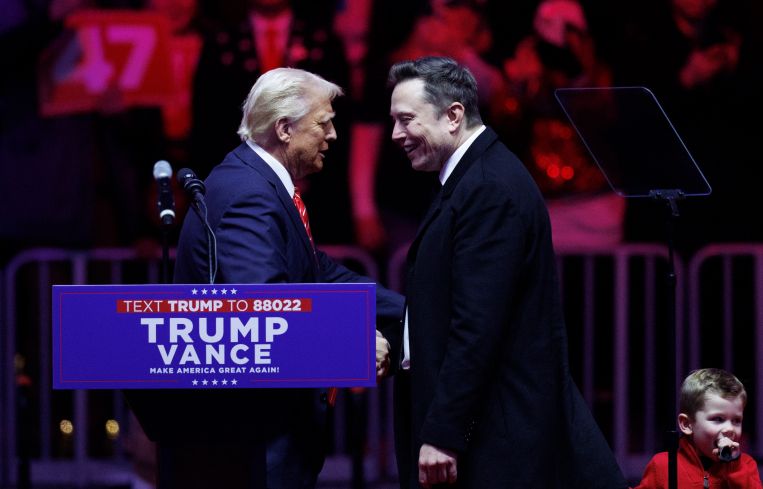 Donald Trump shaking hands with Elon Musk.