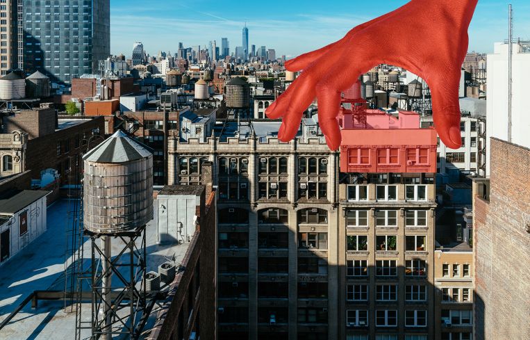 A hand reaching out of the sky and lifting part of a building away.