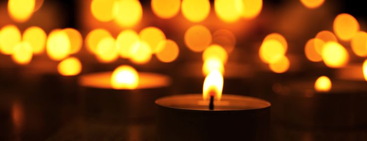Burning candles on dark background