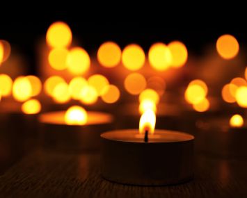 Burning candles on dark background