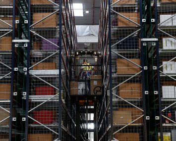 Employees at work inside of a warehouse.