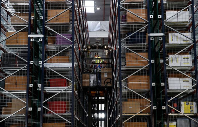 Employees at work inside of a warehouse.