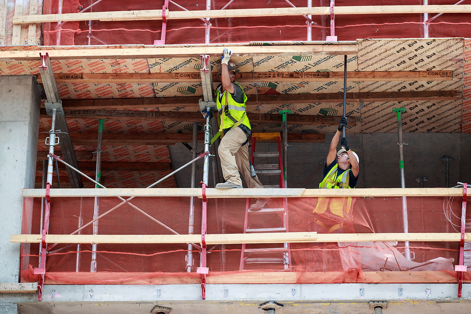 Construction laborers work on a new residential building.