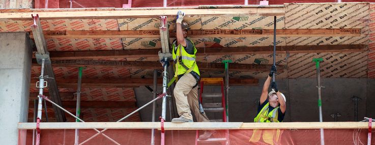 Construction laborers work on a new residential building.