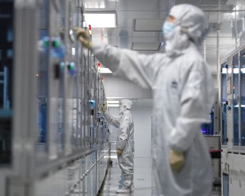 A technician sets the parameters of an automated production line.