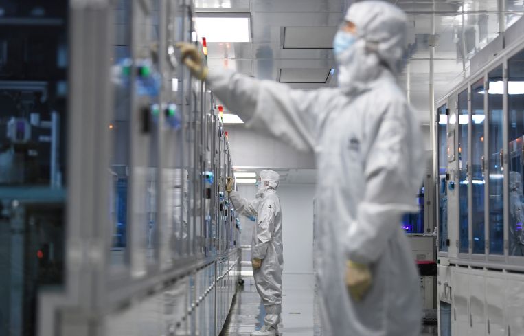 A technician sets the parameters of an automated production line.
