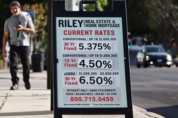 Home mortgage rates are posted outside a real estate office.