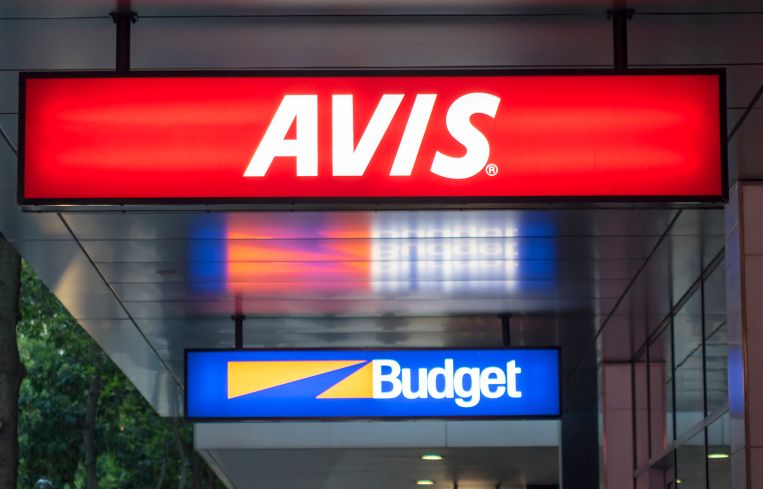 Rental car agencies signs for Avis and Budget.