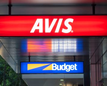 Rental car agencies signs for Avis and Budget.
