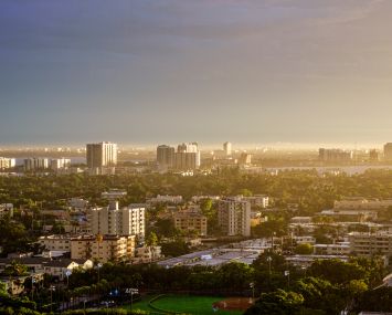 Miami Beach, Florida, aerial view looking down, city skyline buildings residences during break in stormy weather causing floods.