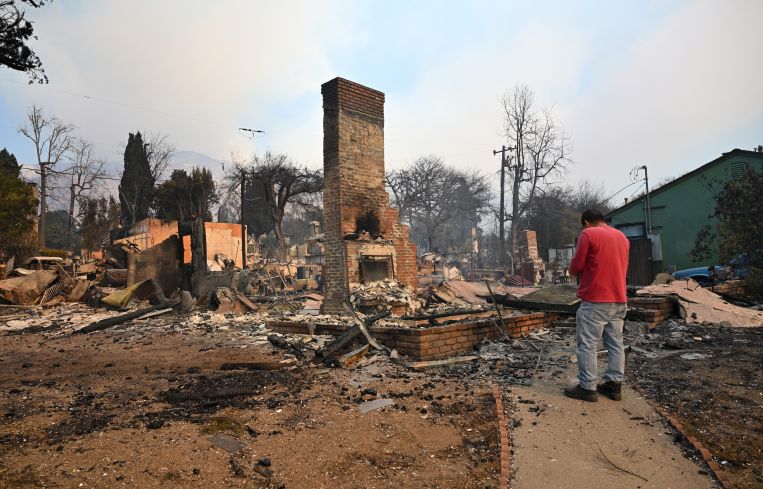 Residents inspect the area among the rubbles of their burnt houses during Eaton wildfire in Altadena of Los Angeles County, California.