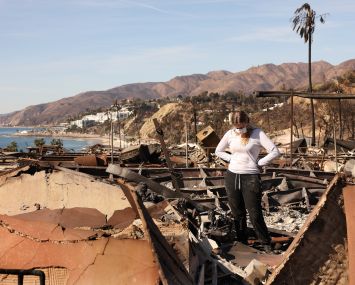 Swea Zamel takes in the damage to her in-laws’ home in the mobile home park Tahitian Terrace in Pacific Palisades.