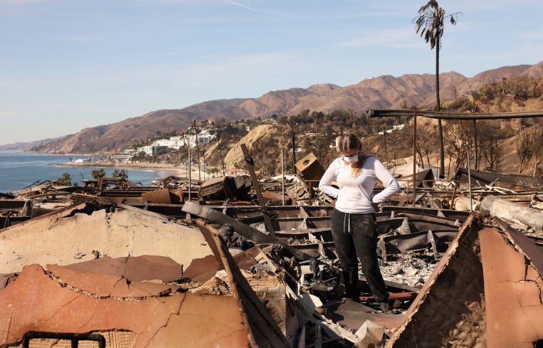 Swea Zamel takes in the damage to her in-laws’ home in the mobile home park Tahitian Terrace in Pacific Palisades.