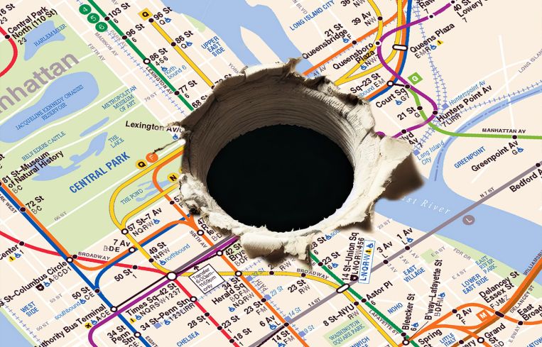 NYC subway map with hole drilled into the center.