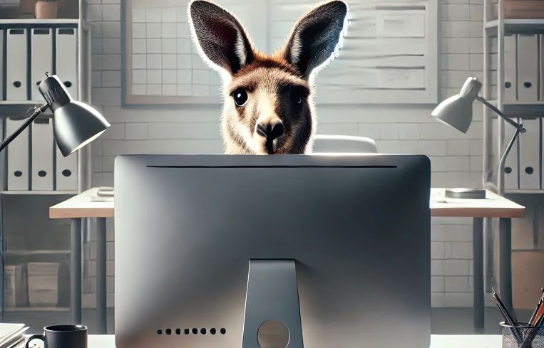 An illustration of a kangaroo looking over a computer monitor.