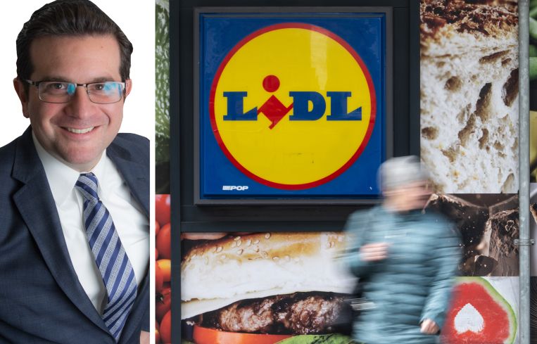 Kenneth Schuckman, President of Schuckman Realty, and a pedestrian passing a Lidl store.