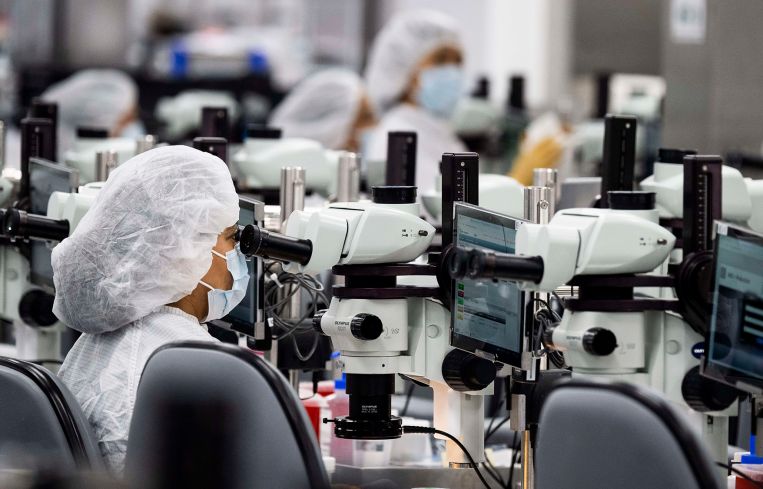 Employees work in a lab at Edwards Lifesciences in Irvine, Calif.