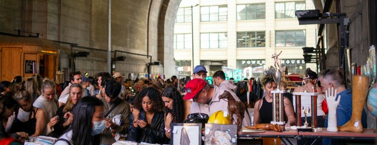 People shop at Brooklyn Flea under the Manhattan Bridge in Brooklyn.