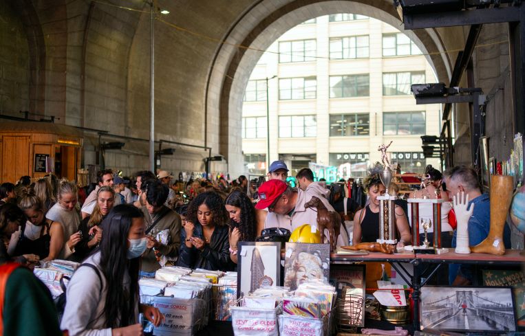 People shop at Brooklyn Flea under the Manhattan Bridge in Brooklyn.