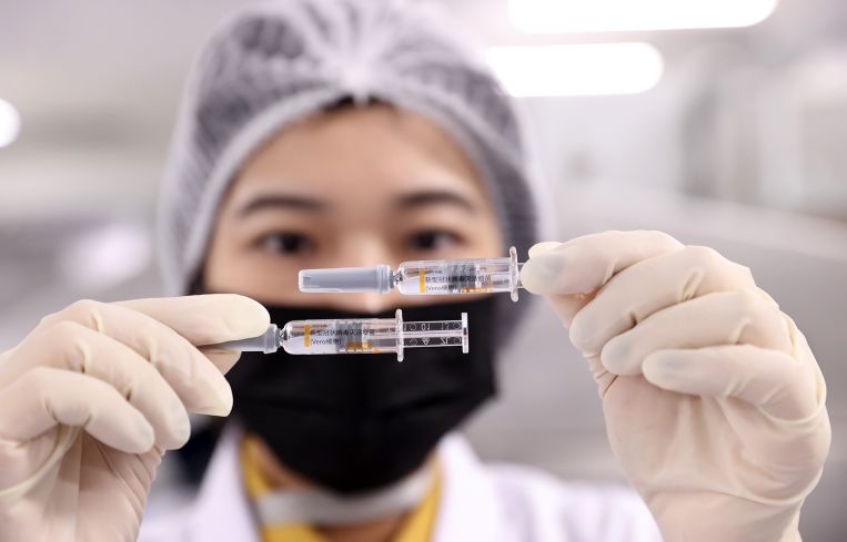 An employee works on the production line of COVID-19 vaccine in Beijing, China.