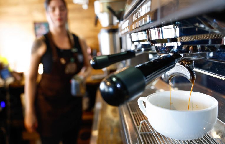A worker prepares a coffee at Colombian coffee shop in New York City.