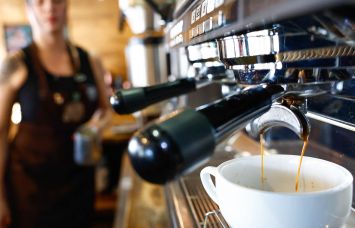 A worker prepares a coffee at Colombian coffee shop in New York City.
