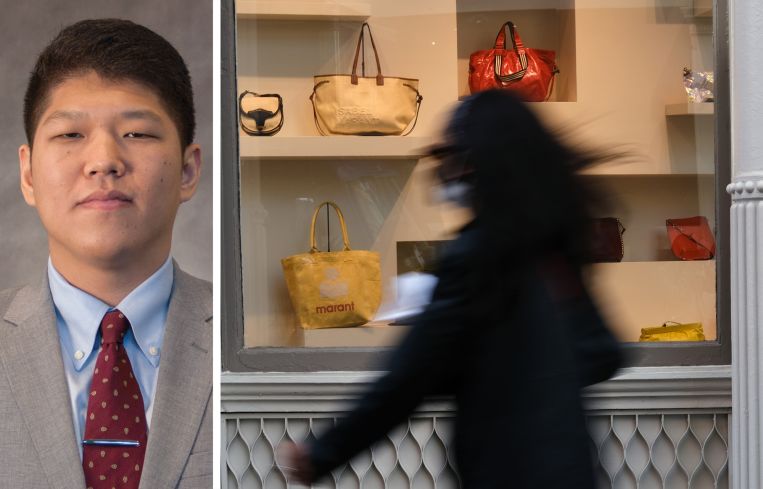 CBRE's Hiro Imaizumi and a pedestrian passes by a window display of luxury handbags.