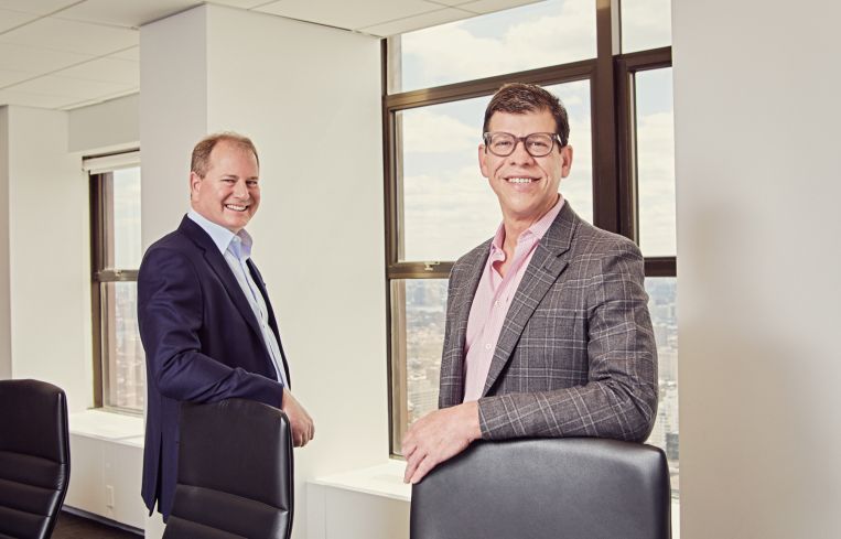 Two men standing in a conference room.